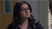 Ariel Winter in Modern Family wearing glasses and a floral shirt. 