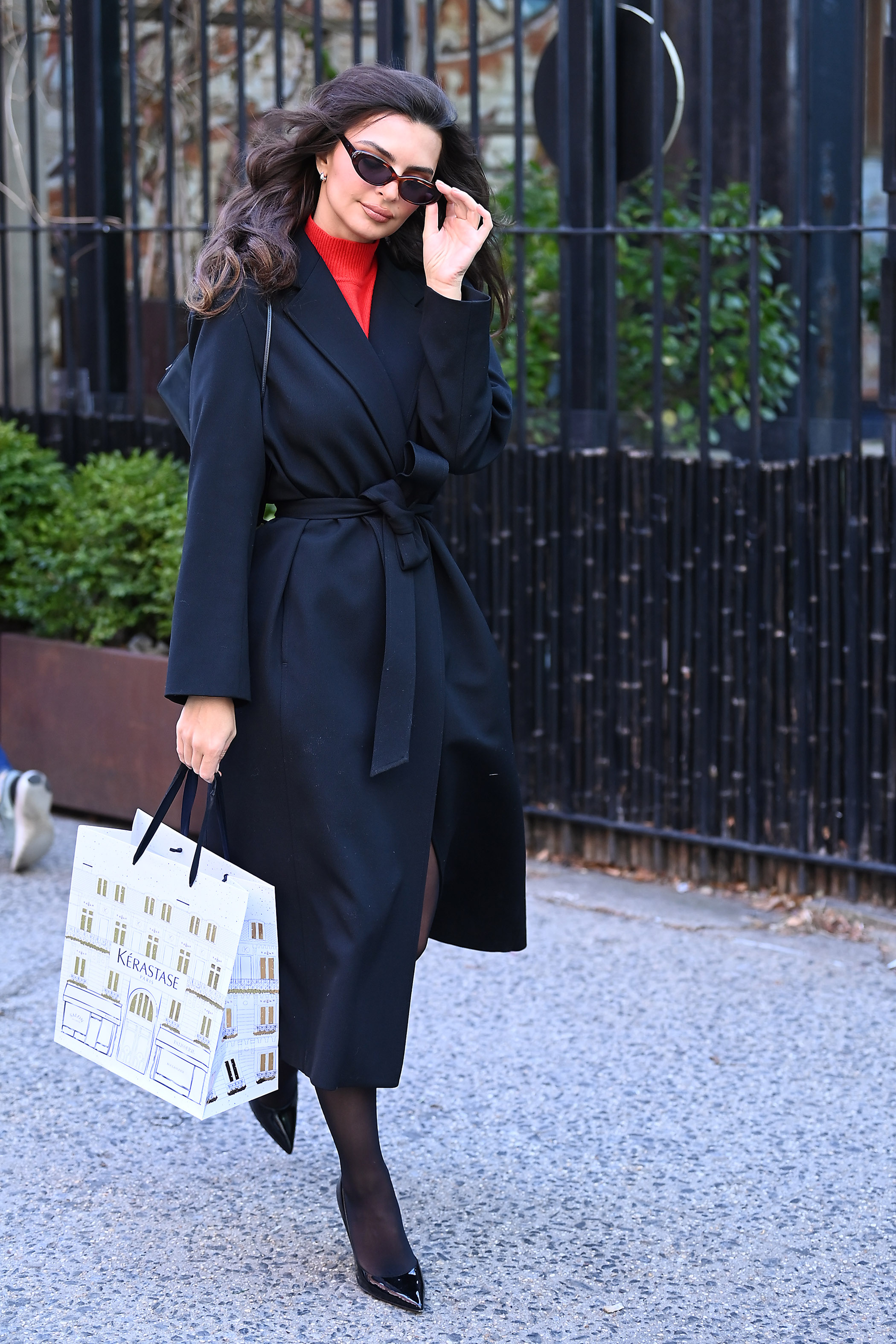 Emily Ratajkowski wears a wrap coat