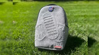 a backpack featuring a mottled grey look similar to the surface of the moon