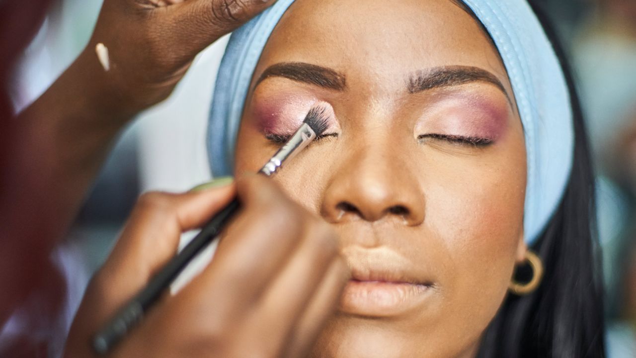 woman having eyeshadow applied