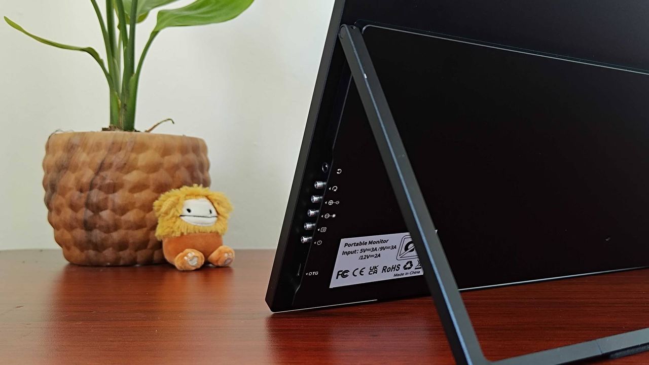 Close up of Uperfect Umax 24 portable monitor buttons on desk.