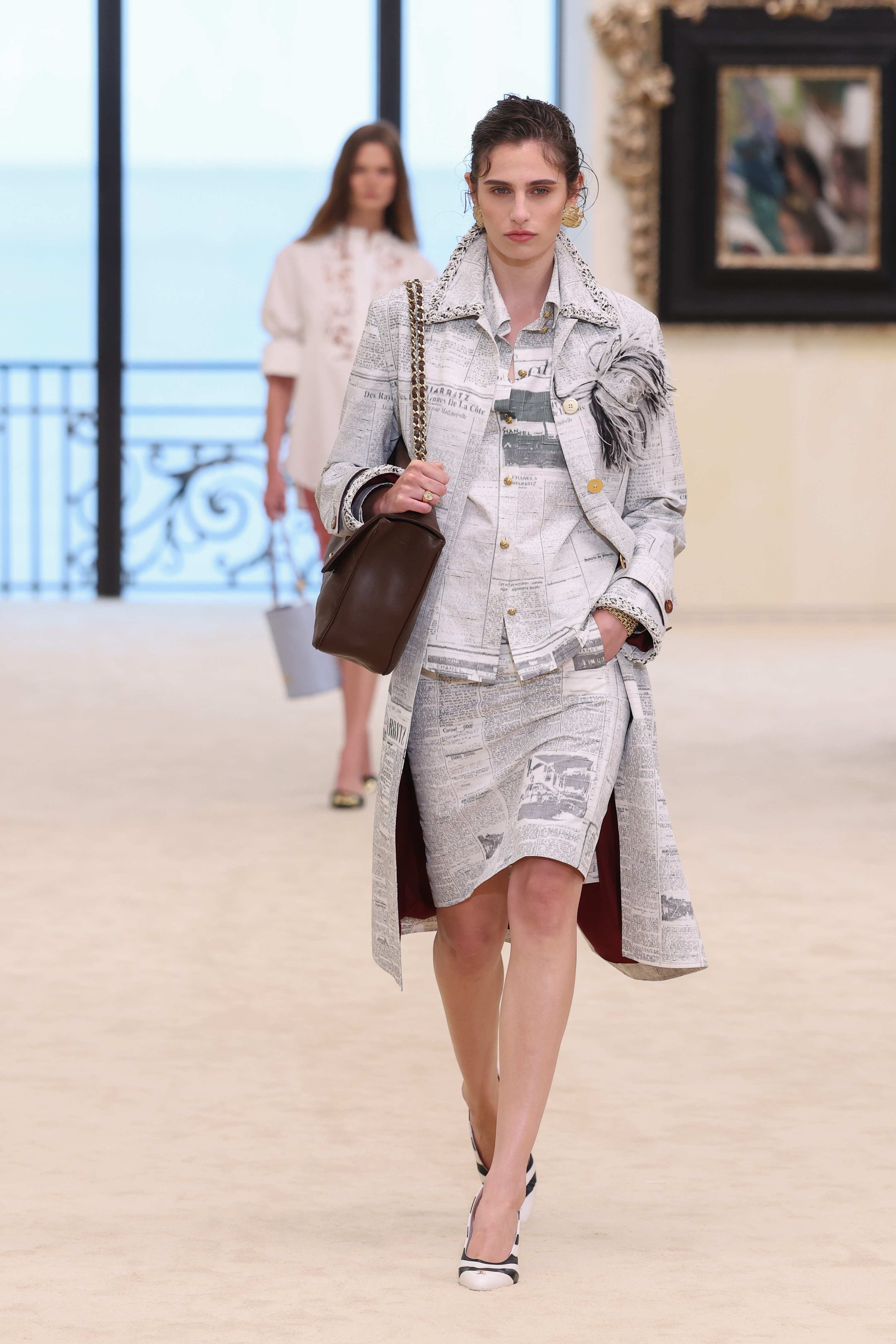 A model wore Chanel's newspaper-print dress on the Cruise 2027 runway