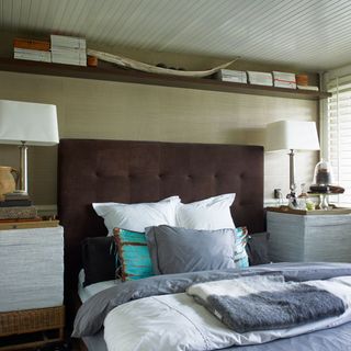 bedroom with cushions on bed and headboard