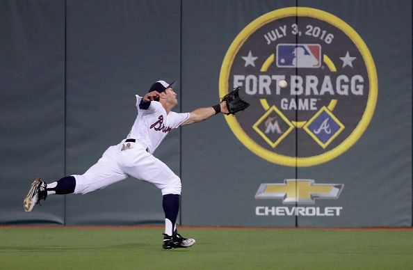 Chase d&amp;#039;Arnaud of the Atlanta Braves dives for a ball during the game Sunday at Fort Bragg.