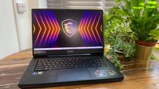 Photos of MSI GT77 on a wooden table at various angles