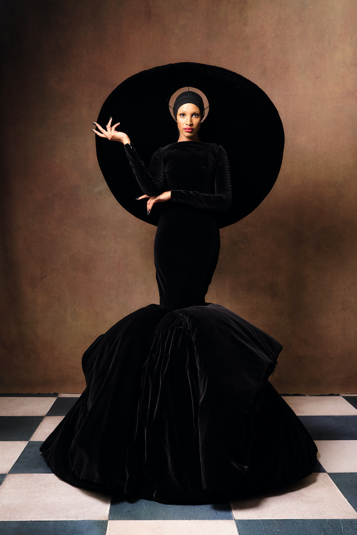 Model wears dramatic Harris Reed hat and dress at London Fashion Week S/S 2023