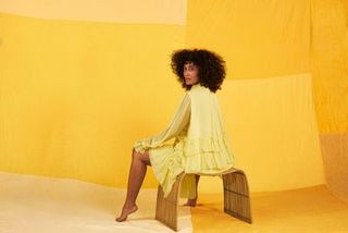 Yellow, Shoulder, Fashion, Joint, Furniture, Fashion design, Sitting, Outerwear, Photography, Dress,
