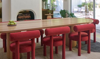 a dining room with red chairs