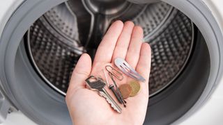 pocket items in front of open washing machine