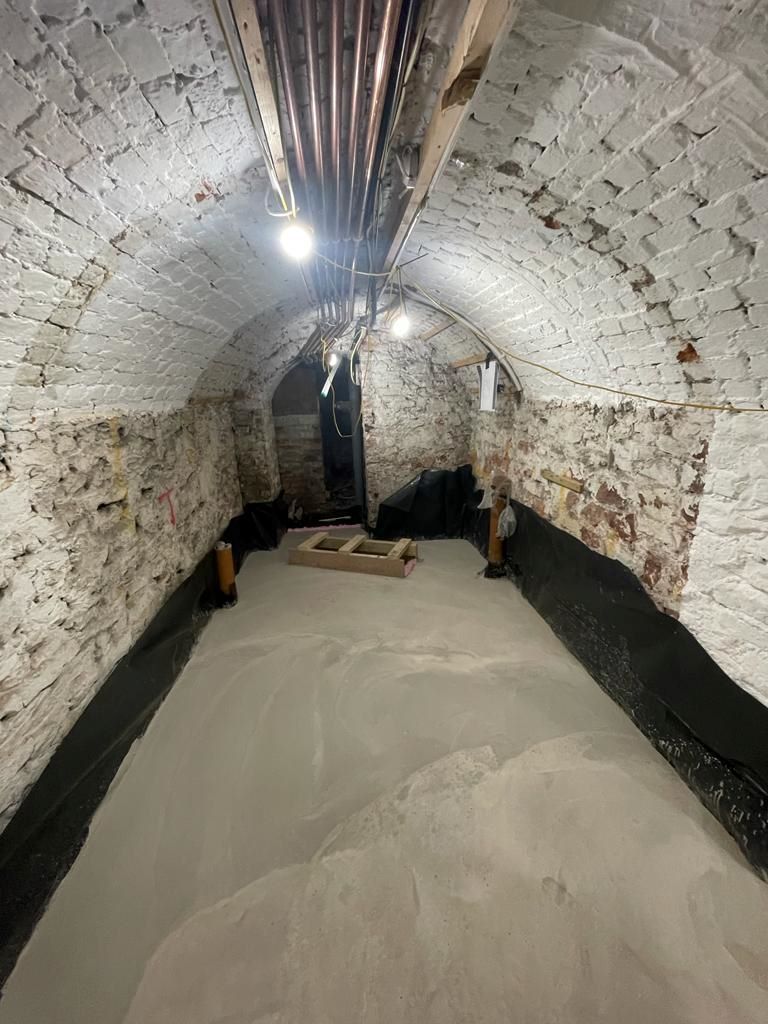The bare brick walls in the air raid shelter