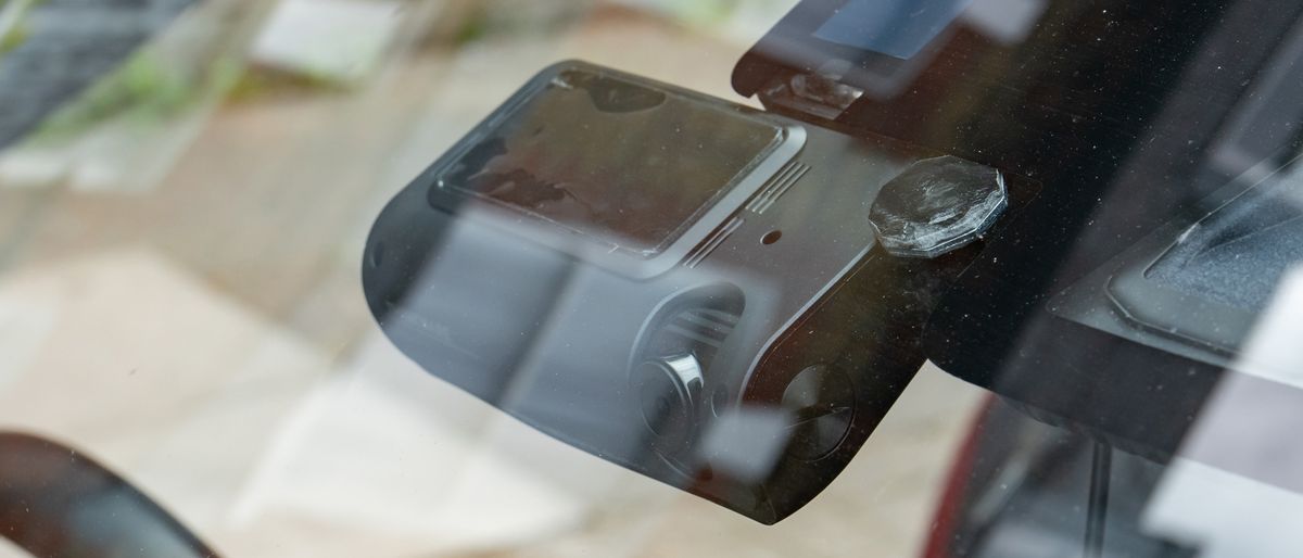 The Thinkware T700 dash cam mounted inside a car&#039;s windscreen