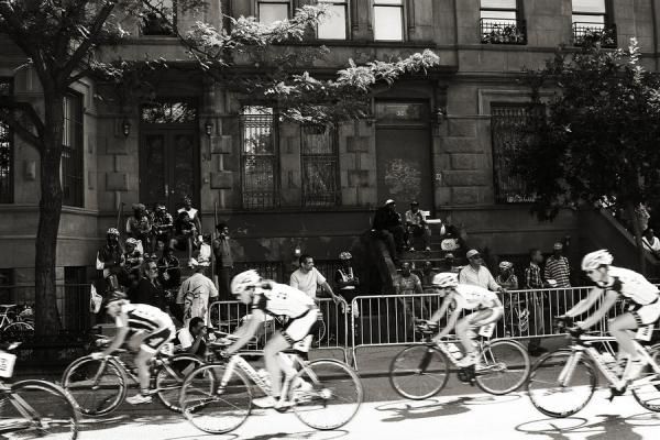 Spectators watching from their "stoops" have a real New York experience here in Harlem.