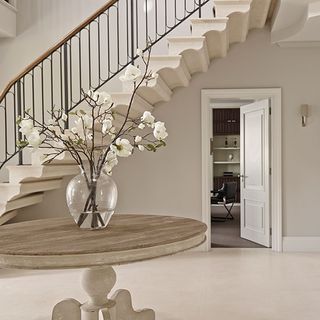 elegant neutral entrance hall with bespoke stone staircase