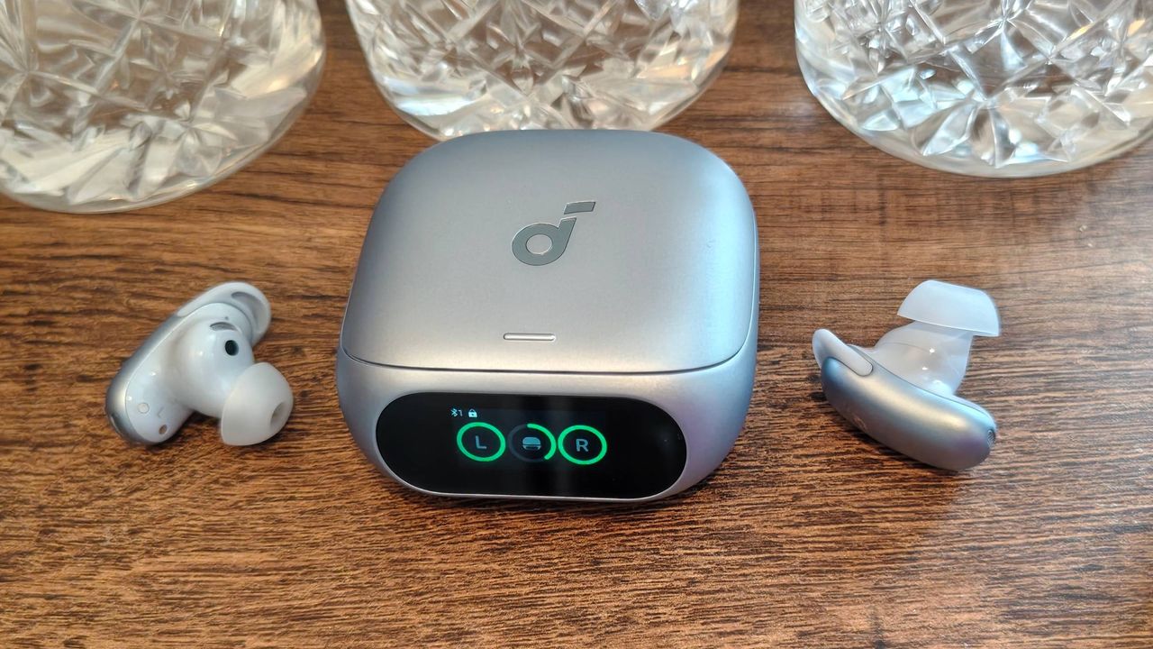 The Anker Soundcore Liberty 5 Pro on a shelf, next to some glasses.