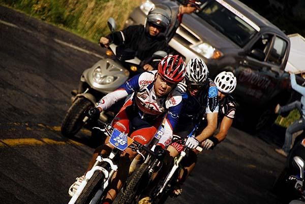 Deiber Esquivel is marked by two MonaVie Cannondale riders.