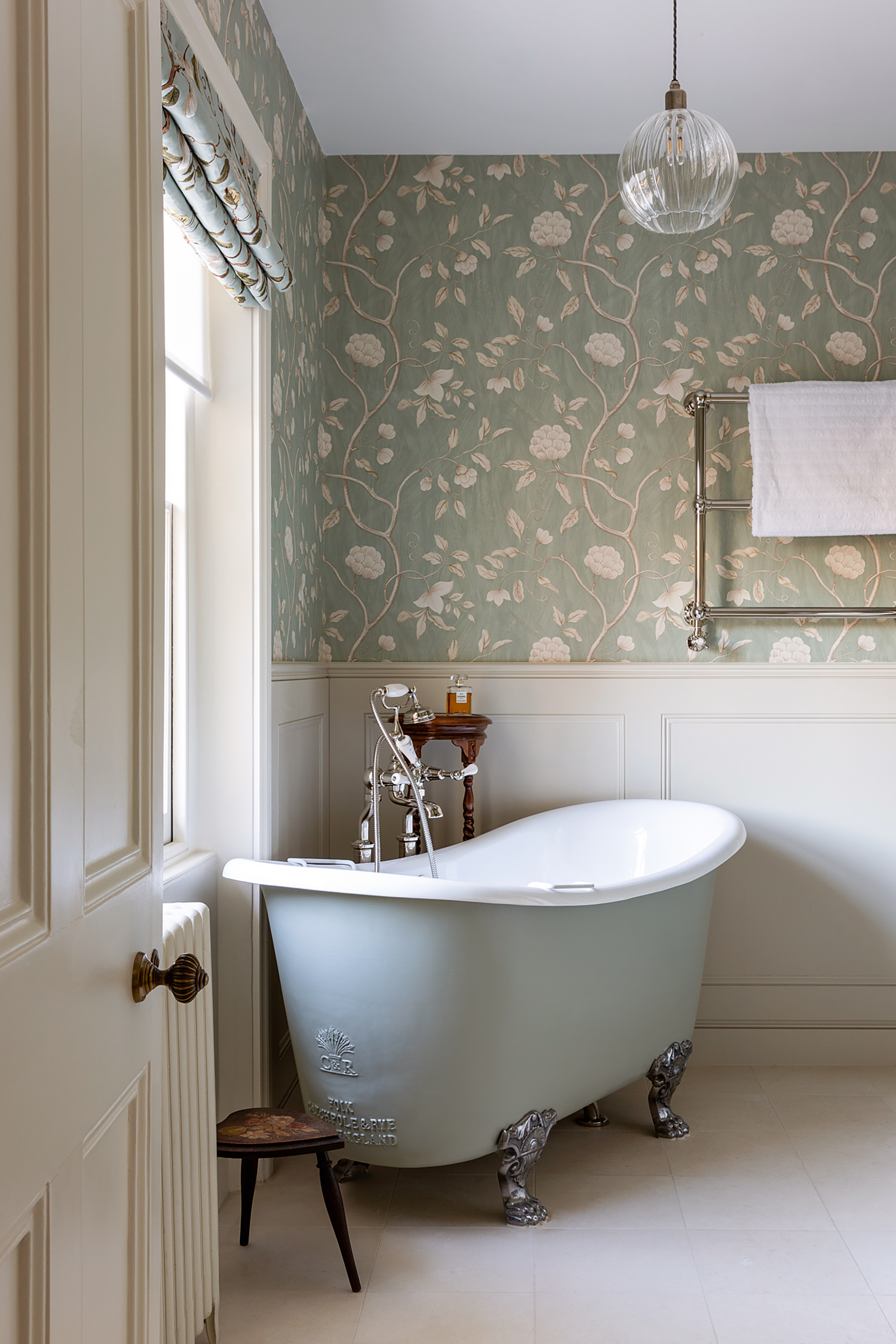 Luxurious vintage bathroom in London with a Catchpole & Rye cast iron roll top bath