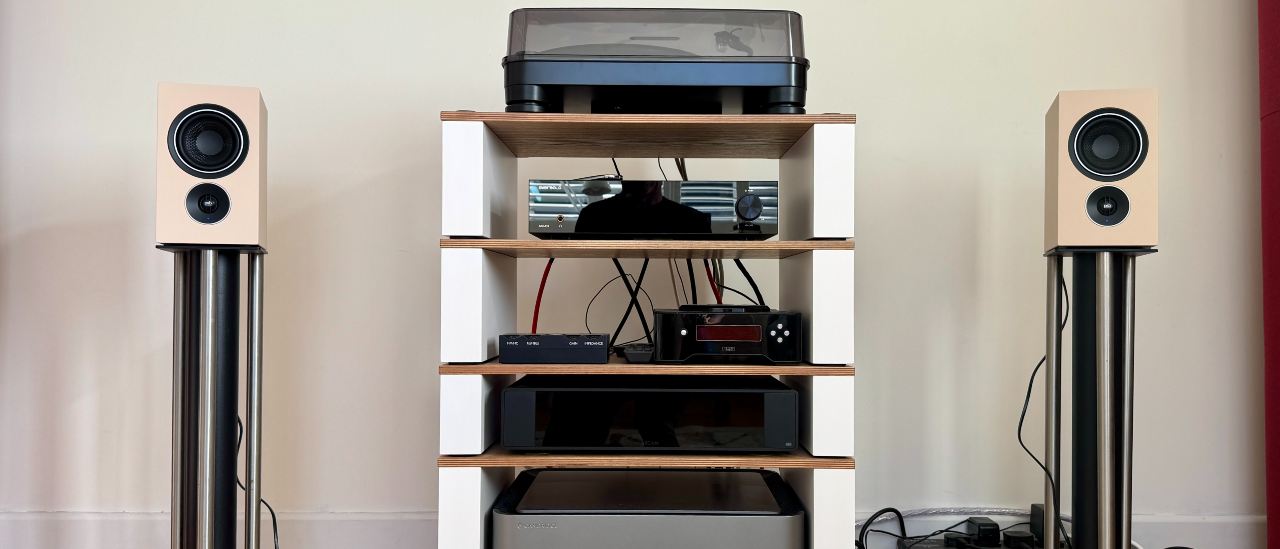 PSB iQ2 stereo speaker system on a wooden surface