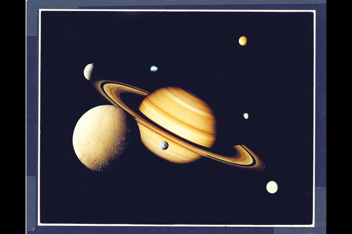 Voyager image shows Saturn and its satellites.