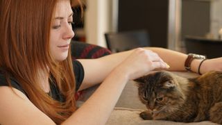 Sony A7C review — a shot of a young woman stroking a cat