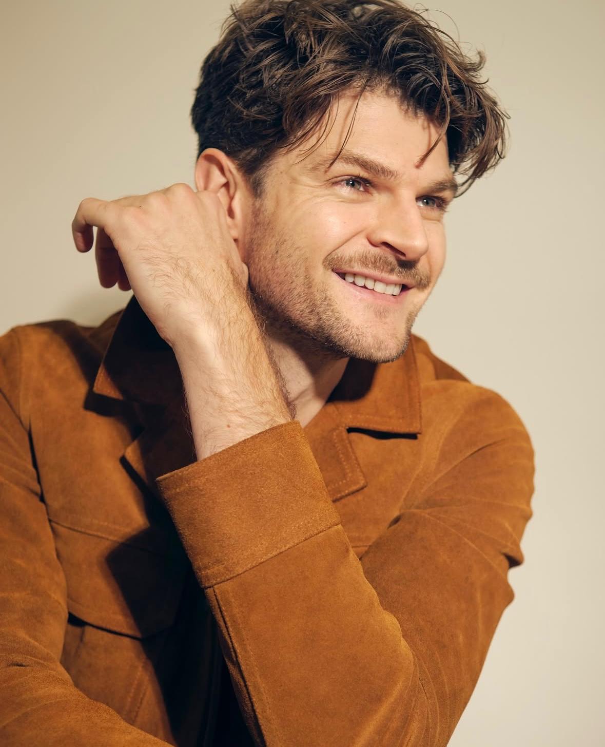 an image of jim chapman in a brown suede jacket