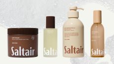 A collage of Saltair bodycare products including the Driftwood multi-lipid body lotion, the Driftwood body oil, the salt water vanilla body wash and Santal Bloom body mist, all arranged in a line across a cream background with a soapy bubble overlay.