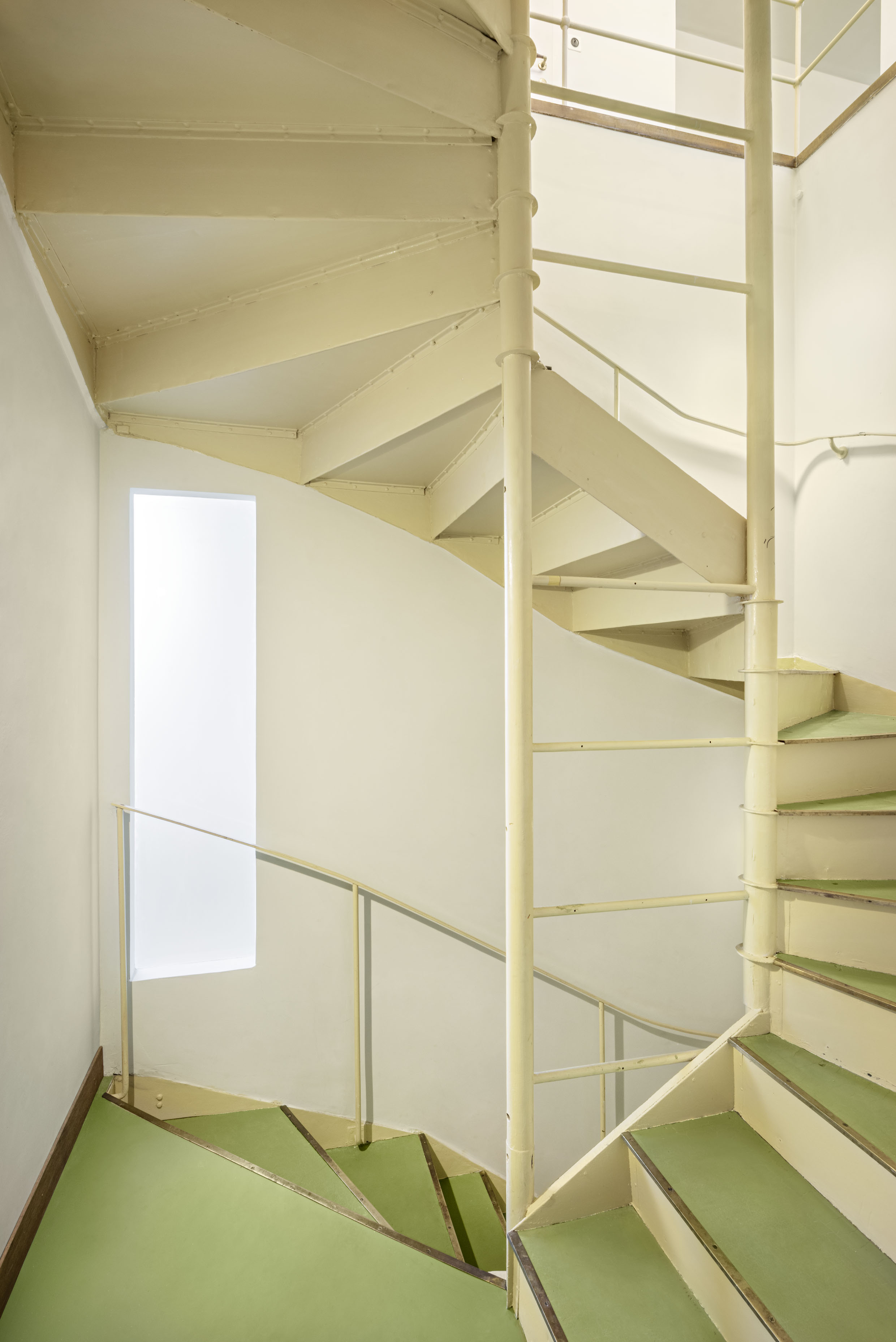 interiors of Villa Beer showing the house restored and clean, sparsely furnished showing off white walls and key furniture pieces