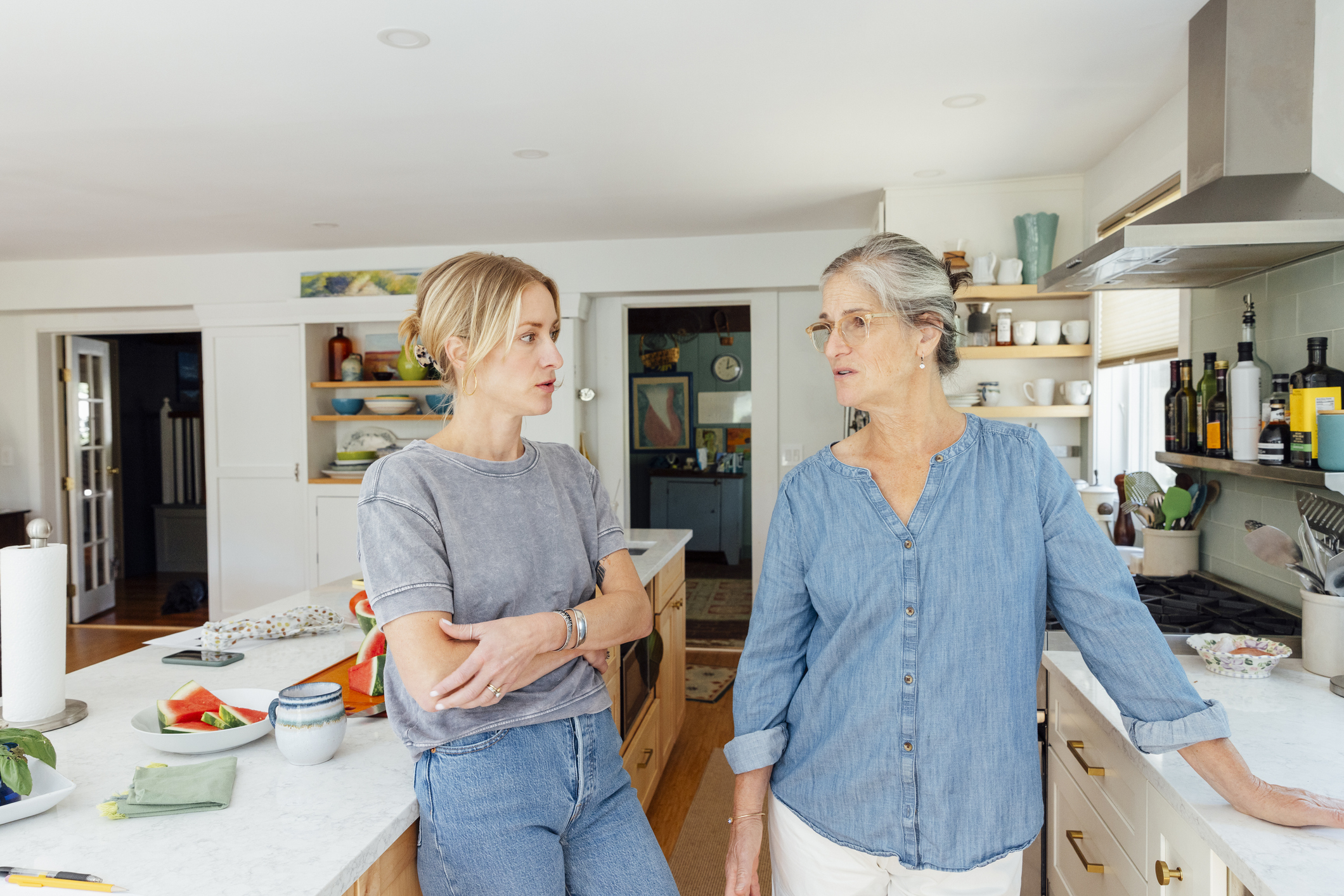 Mother and daughter having a discussion in kitchen