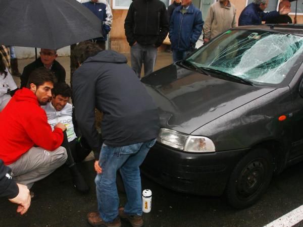 Julian Dean (GreenEdge) receives attention following his crash into a parked car.