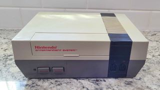 Nintendo Entertainment System (NES) on counter.