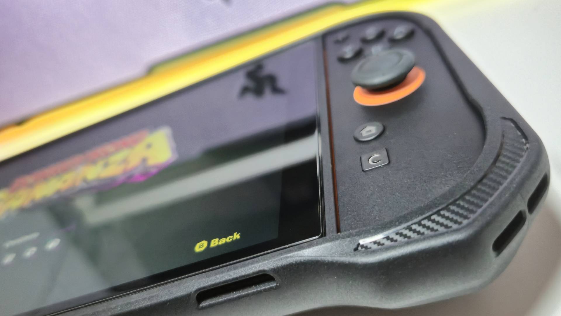 Photo by Rosalie Newcombe of the corner of the Spigen Rugged Armor case sitting on a Switch 2.