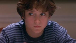 Elijah Wood looks to the side with concern at the dinner table in North.