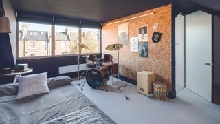 dark blue bedroom in loft conversion with cork wall