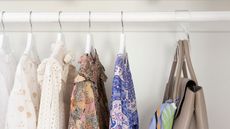 Clean and tidy closet with clothes and purse hanging up