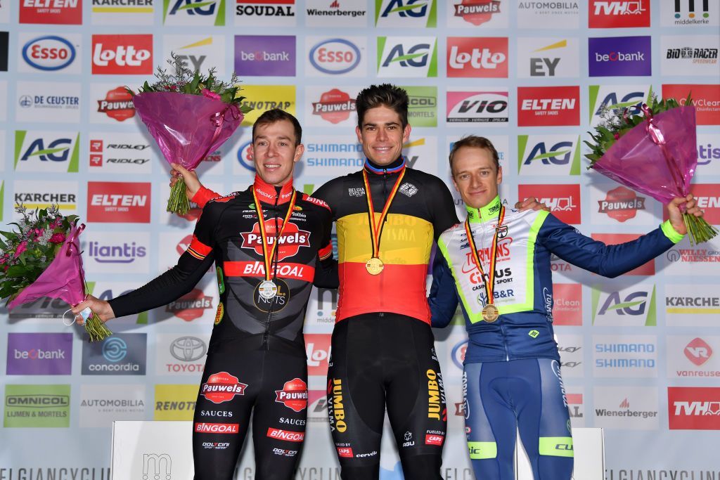 MIDDELKERKE BELGIUM JANUARY 09 LR Silver medalist Laurens Sweeck of Belgium gold medalist Wout Van Aert of of Belgium and bronze medalist Quinten Hermans of Belgium pose on the podium during the medal ceremony after the 105th Belgian National Cyclocross Championships 2022 Mens Elite bkmiddelkerke on January 09 2022 in Middelkerke Belgium Photo by Luc ClaessenGetty Images