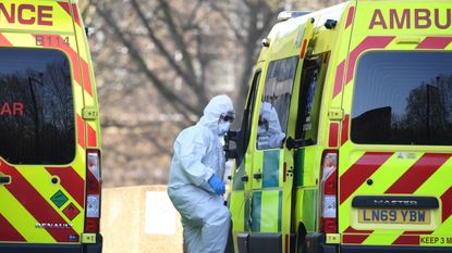 A member of staff climbs into an ambulance at St Thomas' Hospital, London