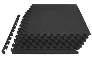 A pile of black sectioned exercise mats.