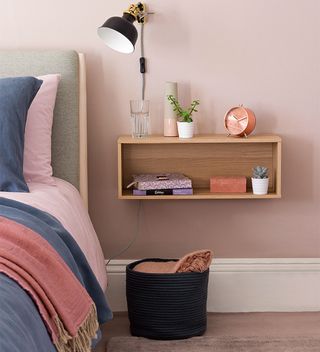 pink bedroom with bed and bedside box shelf