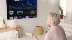 Chromecast with Google TV being used by woman