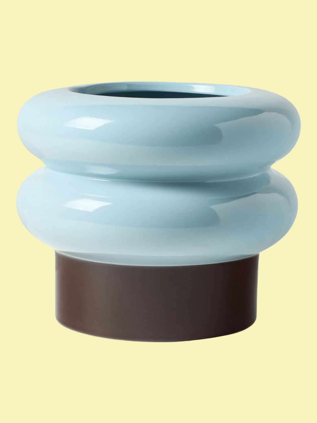 A blue curved planter with a brown base from Westwing