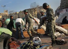Egyptian soldiers haul away makeshift tents in Tahrir Square, Cairo