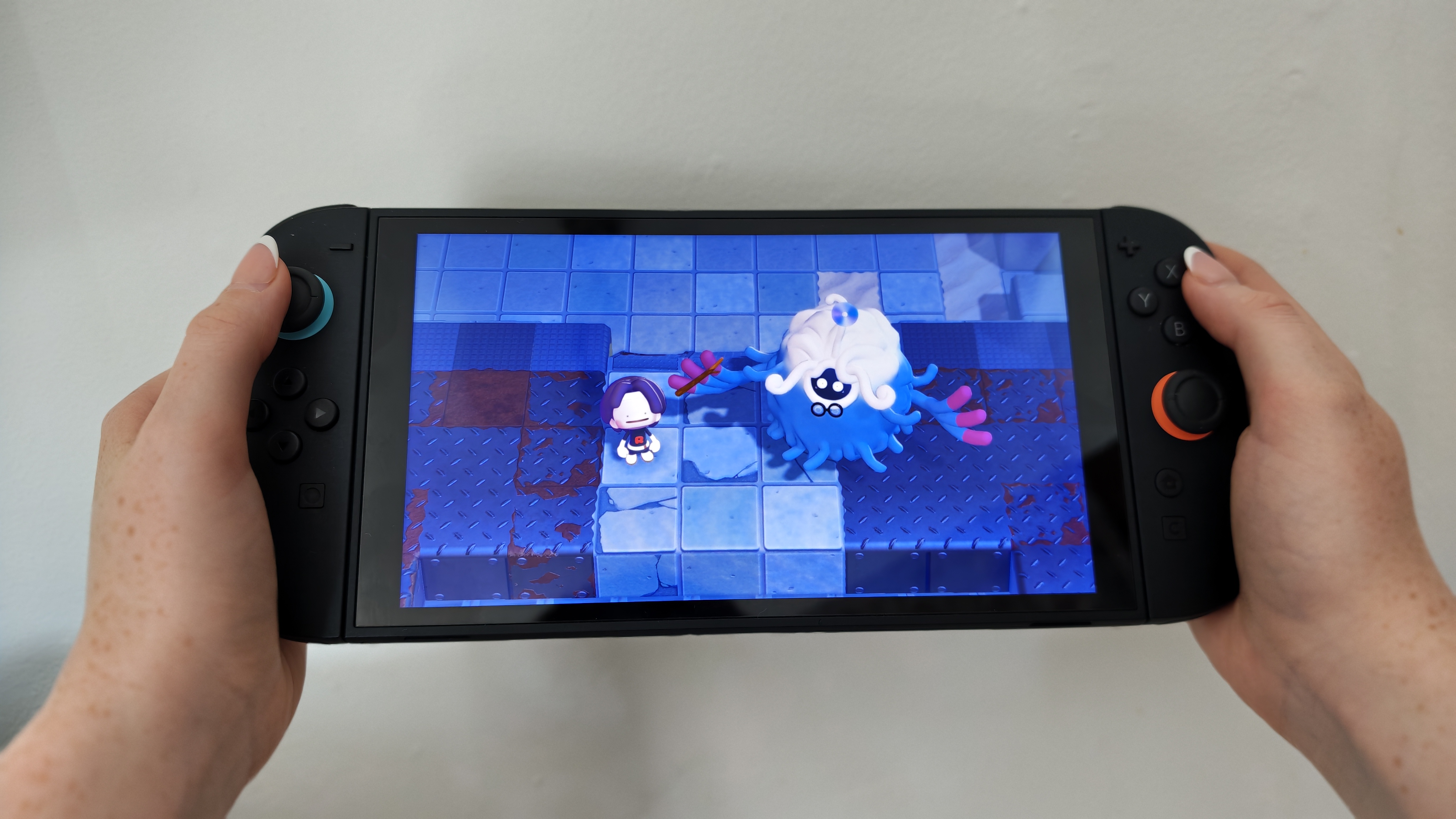Woman playing Pok&amp;eacute;mon Pokopia on Nintendo Switch 2