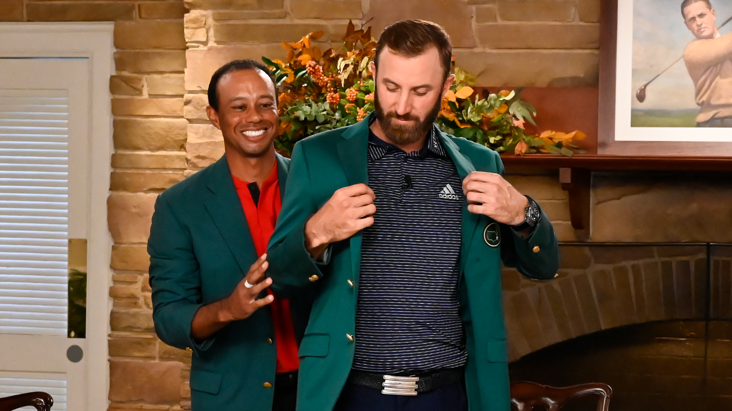 Tiger Woods hands Dustin Johnson the Green Jacket