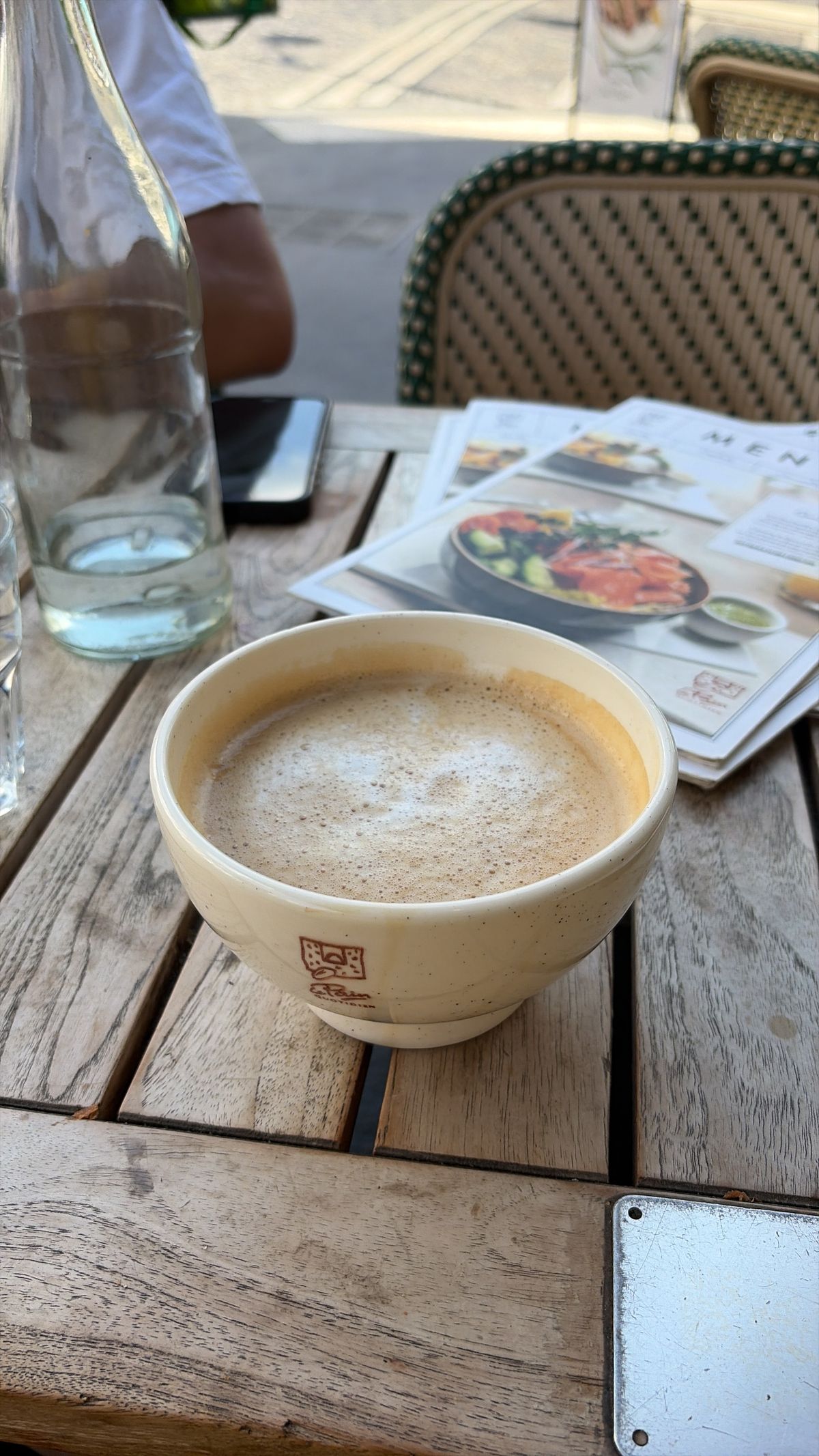 A photo of a coffee cup on a wooden table edited with Clean Up in iOS 27