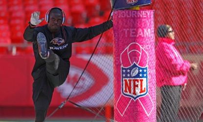A player warms up next to a Kansas City Chiefs field goal post outfitted with special pink padding in honor of Breast Cancer Awareness month.