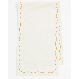cream table runner with a yellow wavy border
