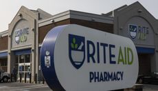 A Rite Aid store with its pharmacy logo sign in front.