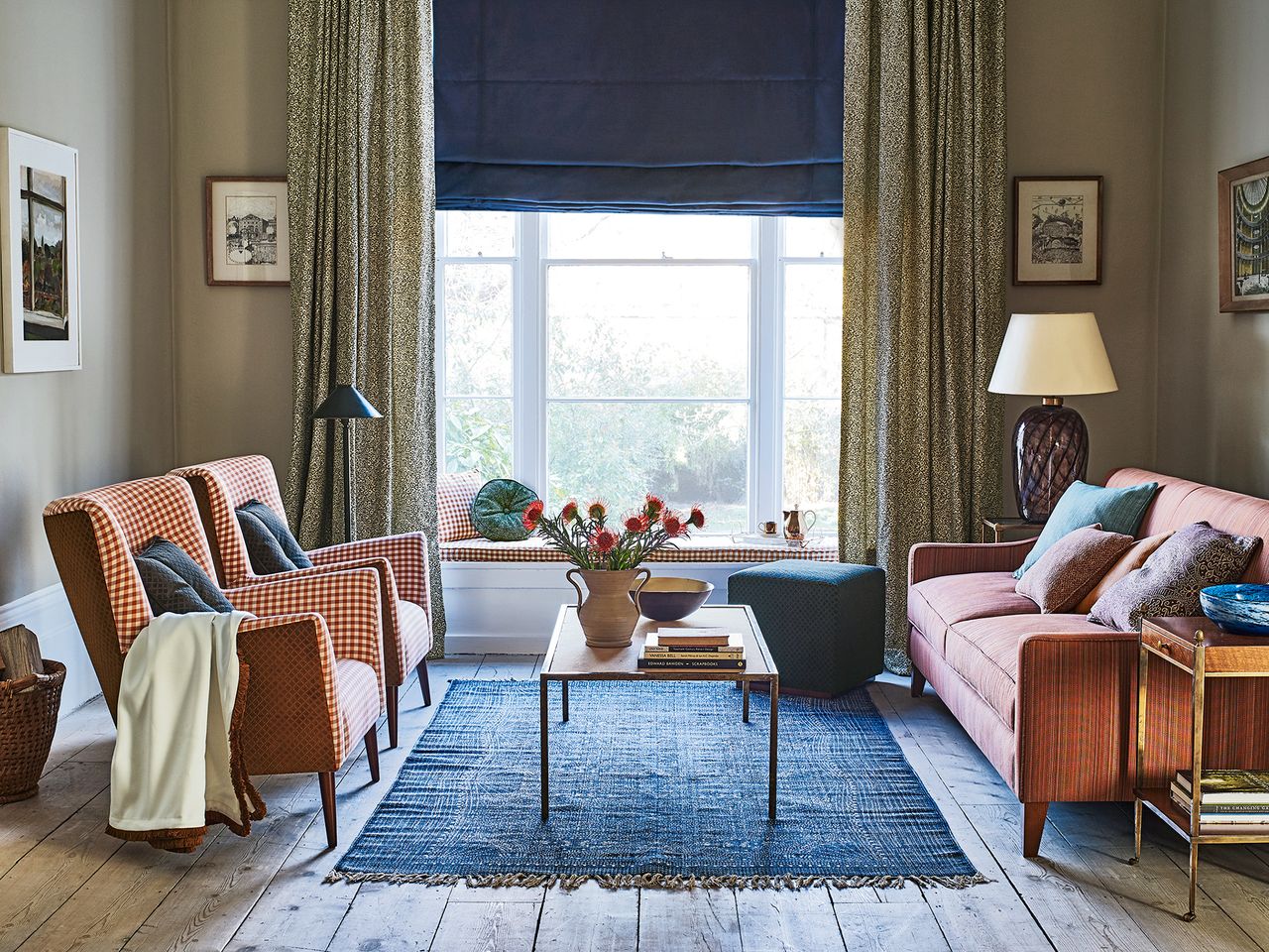 Cozy living room with rust tones, chairs, sofa and window seat