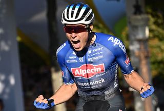 TOPSHOT - Alpecin-Deceuninck team's Belgian rider Jasper Philipsen celebrates as he cycles to the finish line to win the 21st and final stage of the 109th edition of the Tour de France cycling race, 115,6 km between La Defense Arena in Nanterre, outside Paris, and the Champs-Elysees in Paris, France, on July 24, 2022. (Photo by Marco BERTORELLO / AFP) (Photo by MARCO BERTORELLO/AFP via Getty Images)