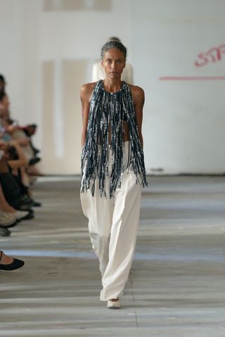 a model wears a rachel comey look while walking the runway at new york fashion week