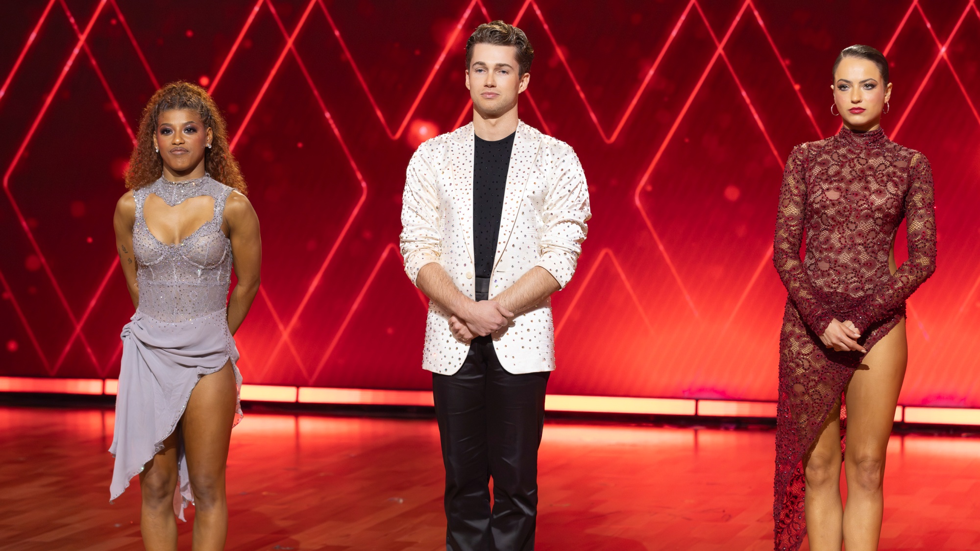 Dancing with the Stars: The Next Pro finalists Selena Hamilton, AJ Pritchard and Adele Zaikman standing on stage.